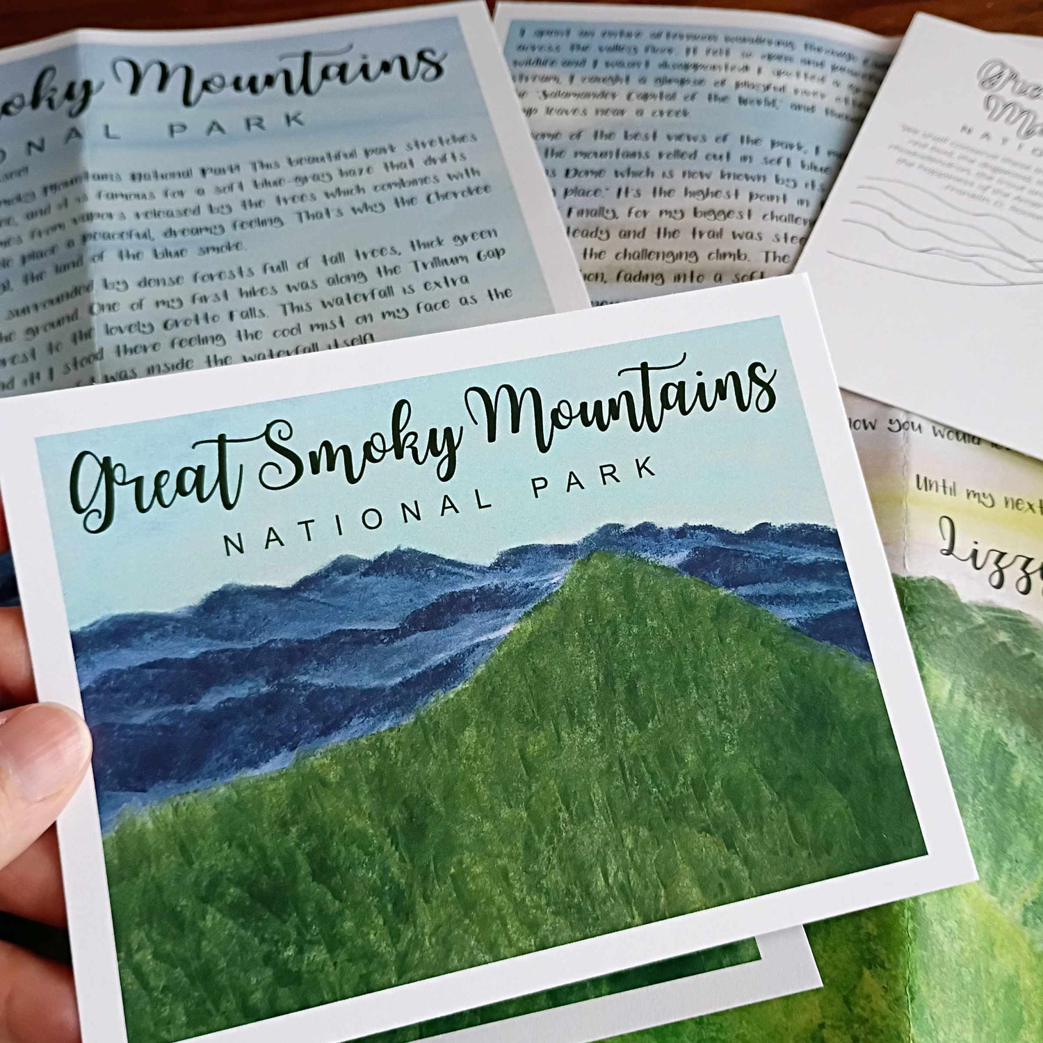 Card with 'Great Smoky Mountains National Park' design held by a hand